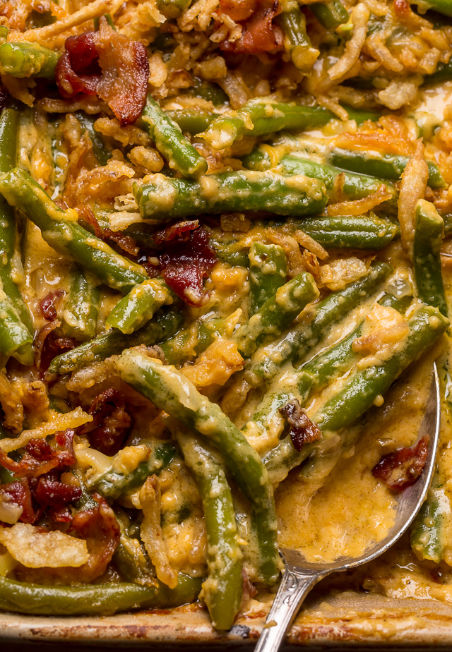 Baked green bean casserole in baking dish with serving spoon.