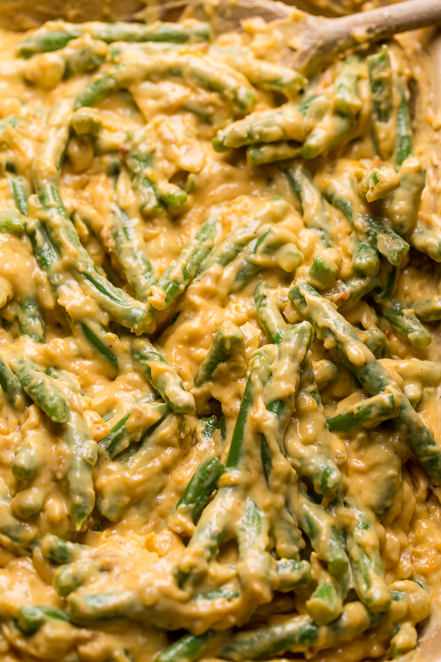Fresh green beans covered in creamy cheese sauce for green bean casserole.