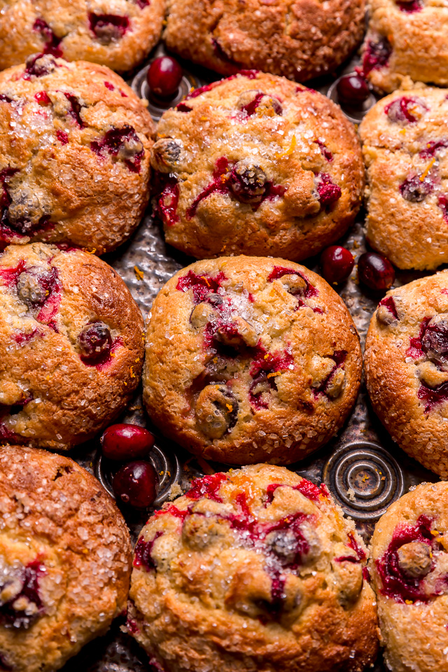 Muffin pan with cranberry orange muffins in it.