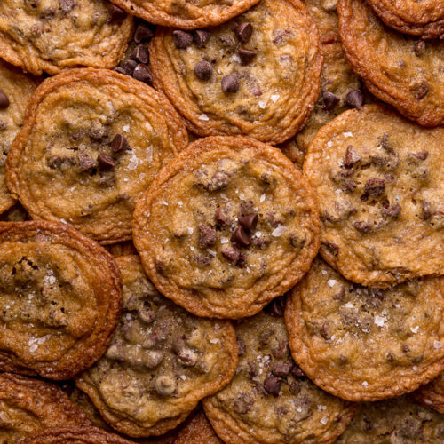Bust out your cookie sheet, because these thin crispy chocolate chip cookies are a must bake! These cookies bake up golden brown and smell like heaven! Super thin and delightful crisp, these are one of our favorite chocolate chip cookie recipes!