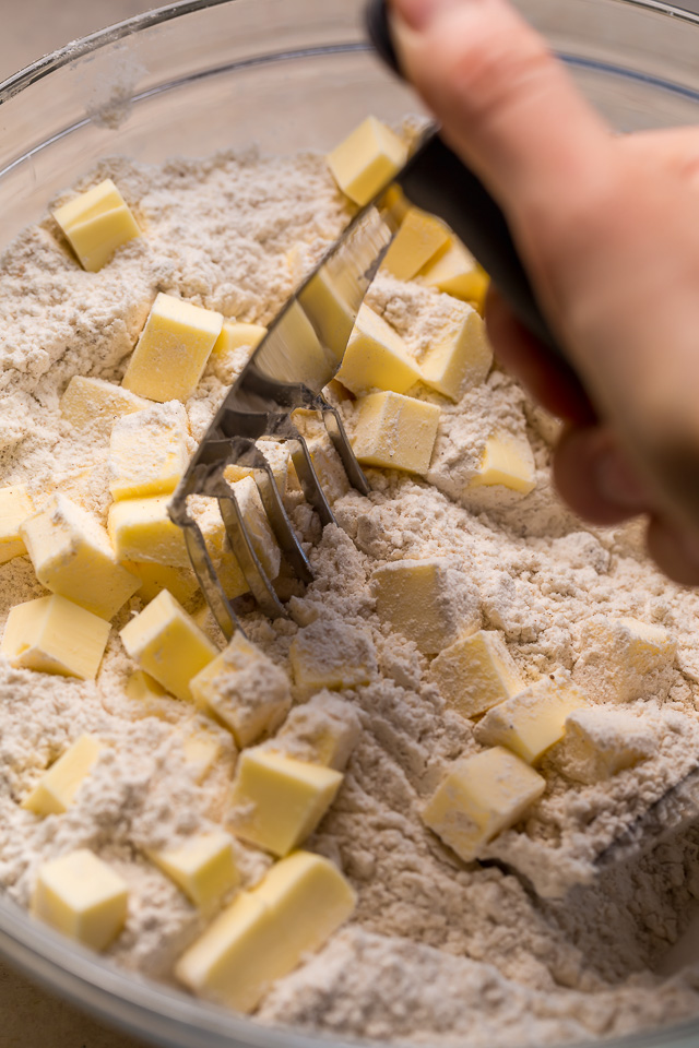These Bakery-Style Eggnog Scones are flaky, buttery, and loaded with eggnog flavor! Topped with a sweet eggnog glaze, they're perfect for Christmas morning! Best served warm, with a cup of coffee or tea!