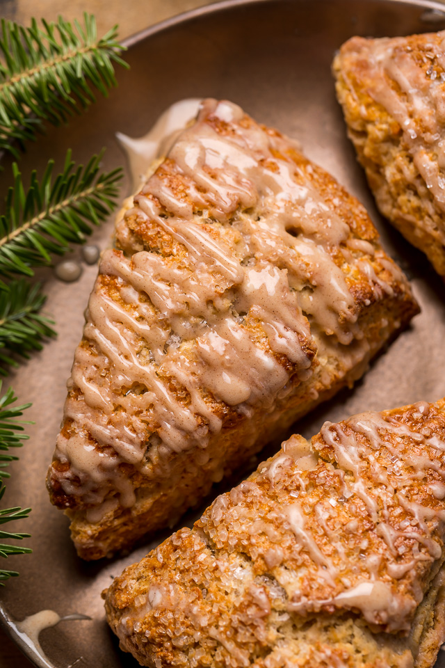 These Bakery-Style Eggnog Scones are flaky, buttery, and loaded with eggnog flavor! Topped with a sweet eggnog glaze, they're perfect for Christmas morning! Best served warm, with a cup of coffee or tea!