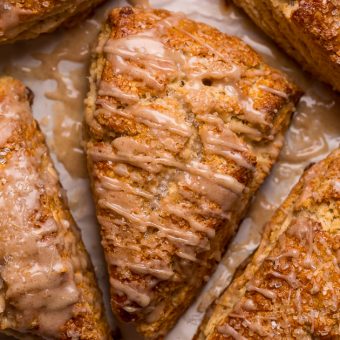 These Bakery-Style Eggnog Scones are flaky, buttery, and loaded with eggnog flavor! Topped with a sweet eggnog glaze, they're perfect for Christmas morning! Best served warm, with a cup of coffee or tea!