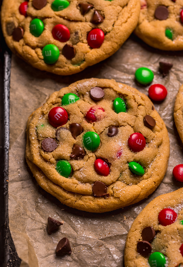 Santa's Favorite Peanut Butter M&M Cookies are thick, soft, and chewy! These GIANT bakery-style holiday cookies are loaded with peanut butter, M&Ms, and gooey milk chocolate chips! A crowd-pleasing cookie recipe that's loved equally by kiddos and adults!