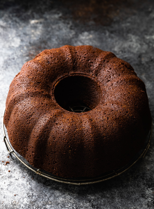 Chocolate bundt cake on a cooling rack.