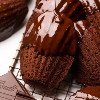 My Double Chocolate Madeleines are fluffy, cakey, and perfect for dunking in tea or coffee! A sweet treat that's sure to please the chocolate lovers in your life! So bust out your madeleine pan and let's get baking!