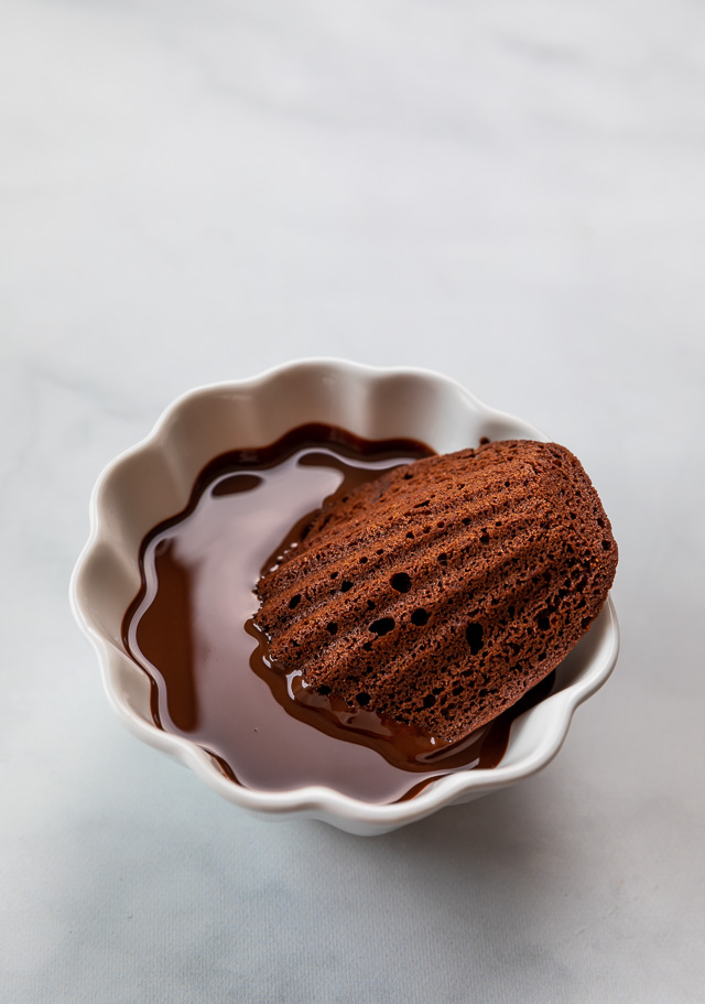 My Double Chocolate Madeleines are fluffy, cakey, and perfect for dunking in tea or coffee! A sweet treat that's sure to please the chocolate lovers in your life! So bust out your madeleine pan and let's get baking!