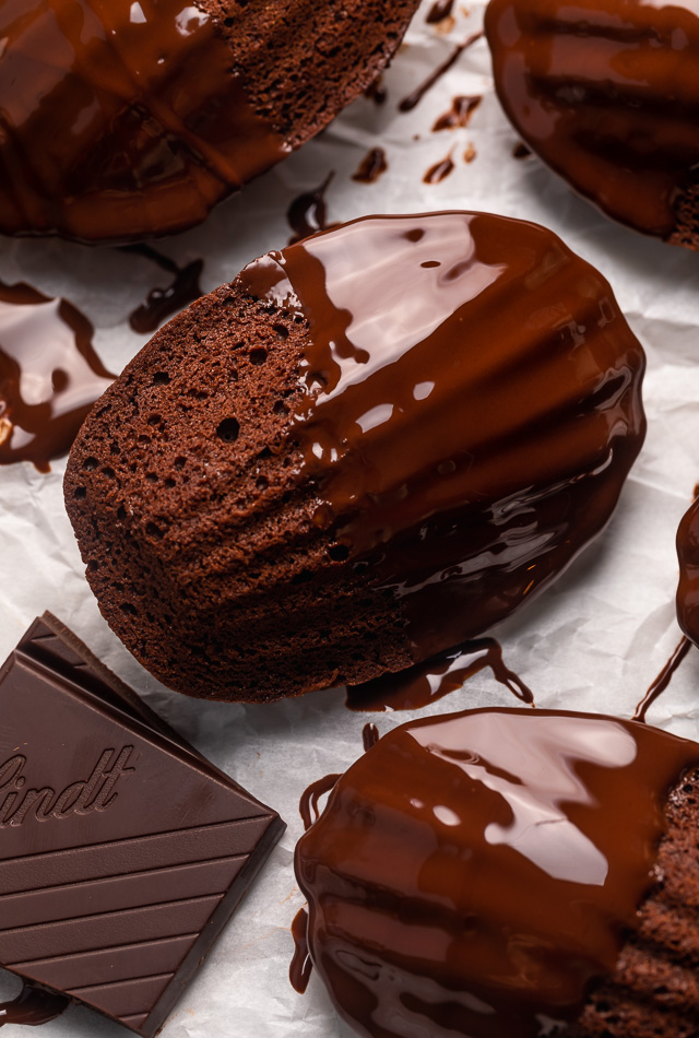 My Double Chocolate Madeleines are fluffy, cakey, and perfect for dunking in tea or coffee! A sweet treat that's sure to please the chocolate lovers in your life! So bust out your madeleine pan and let's get baking!