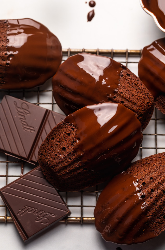 My Double Chocolate Madeleines are fluffy, cakey, and perfect for dunking in tea or coffee! A sweet treat that's sure to please the chocolate lovers in your life! So bust out your madeleine pan and let's get baking!