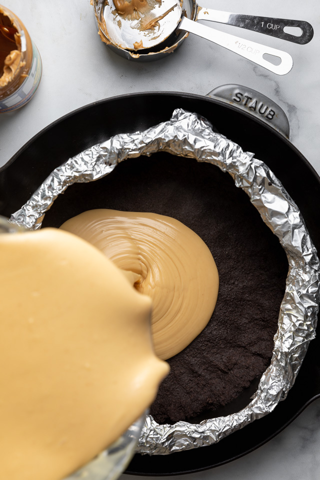 This Chocolate Covered Peanut Butter Cheesecake is ultra creamy and the perfect marriage of chocolate and peanut butter! Featuring an oreo crust, creamy peanut butter cheesecake filling, and topped with with peanut butter chocolate ganache and peanut butter cups, it's a true showstopper! And any leftovers freeze great!