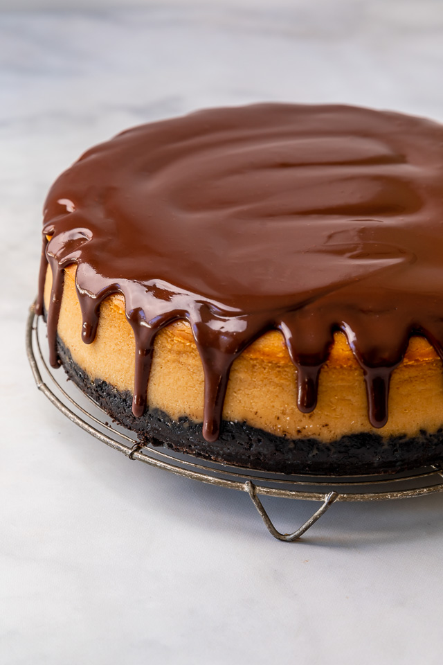 This Chocolate Covered Peanut Butter Cheesecake is ultra creamy and the perfect marriage of chocolate and peanut butter! Featuring an oreo crust, creamy peanut butter cheesecake filling, and topped with with peanut butter chocolate ganache and peanut butter cups, it's a true showstopper! And any leftovers freeze great!