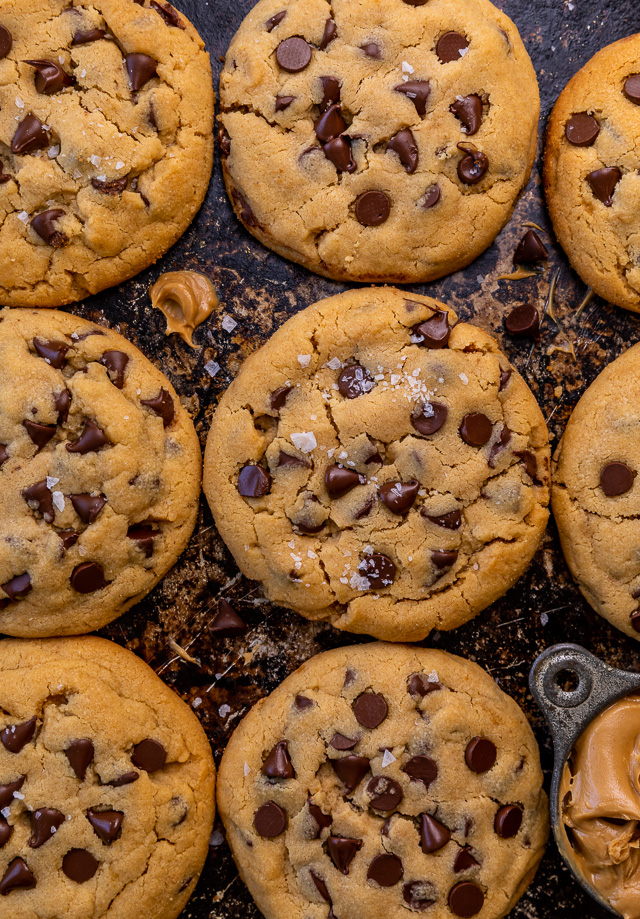 These Bakery-Style Chocolate Chip Cookies are super thick, rich in peanut butter flavor, and loaded with gooey chocolate chips! Press extra chocolate chips on top and sprinkle with sea salt for an impressive presentation! A great recipe for anyone who loves the combination of chocolate and peanut butter!