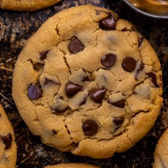 These Bakery-Style Chocolate Chip Cookies are super thick, rich in peanut butter flavor, and loaded with gooey chocolate chips! Press extra chocolate chips on top and sprinkle with sea salt for an impressive presentation! A great recipe for anyone who loves the combination of chocolate and peanut butter!
