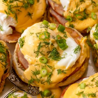 Featuring golden brown toasted English muffins, poached eggs, slices of Canadian bacon, and hollandaise sauce, this Eggs Benedict recipe is pure perfection! Top with freshly chopped dill and scallions, or simply serve with salt and pepper. Perfect for any special at-home breakfast or brunch!