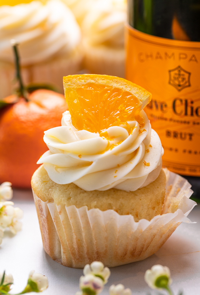 Today I'm teaching you how to make Mimosa Cupcakes! Light and fluffy, these delicious cupcakes are made with freshly squeezed orange juice, orange zest, and of course, CHAMPAGNE! One of my favorite cupcake recipes for brunch or special occasions like Easter, Mother's Day, or New Year's Eve!