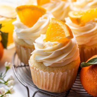 Today I'm teaching you how to make Mimosa Cupcakes! Light and fluffy, these delicious cupcakes are made with freshly squeezed orange juice, orange zest, and of course, CHAMPAGNE! One of my favorite cupcake recipes for brunch or special occasions like Easter, Mother's Day, or New Year's Eve!