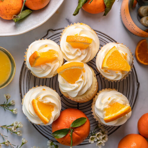 Today I'm teaching you how to make Mimosa Cupcakes! Light and fluffy, these delicious cupcakes are made with freshly squeezed orange juice, orange zest, and of course, CHAMPAGNE! One of my favorite cupcake recipes for brunch or special occasions like Easter, Mother's Day, or New Year's Eve!