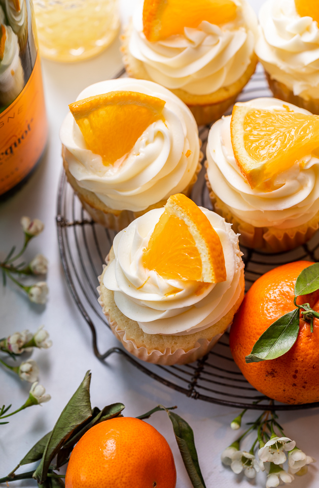 Today I'm teaching you how to make Mimosa Cupcakes! Light and fluffy, these delicious cupcakes are made with freshly squeezed orange juice, orange zest, and of course, CHAMPAGNE! One of my favorite cupcake recipes for brunch or special occasions like Easter, Mother's Day, or New Year's Eve!
