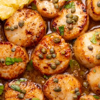 Perfectly pan seared scallops are served in a delicious white wine lemon caper sauce! This special occasion recipe is so easy and comes together in less than 20 minutes! Just be sure not to overcook your scallops, only cook for 1 minute and 30 seconds or so per side!