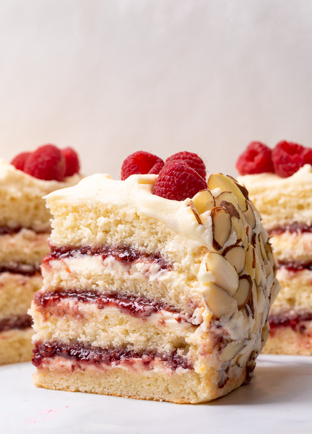 Three slices of white chocolate raspberry cake on a table.