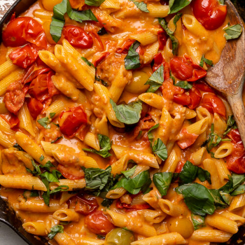 Fresh Tomato Basil Penne alla Vodka is rich, creamy, and so flavorful! The vodka sauce is made with olive oil, a bounty of fresh cherry tomatoes, plenty of garlic, and just a touch of crushed red pepper flakes - plus vodka, cream, and tons of fresh basil! This restaurant quality penne alla vodka recipe is sure to become a family favorite!