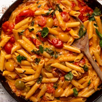 Fresh Tomato Basil Penne alla Vodka is rich, creamy, and so flavorful! The vodka sauce is made with olive oil, a bounty of fresh cherry tomatoes, plenty of garlic, and just a touch of crushed red pepper flakes - plus vodka, cream, and tons of fresh basil! This restaurant quality penne alla vodka recipe is sure to become a family favorite!