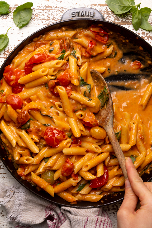 Fresh Tomato Basil Penne alla Vodka is rich, creamy, and so flavorful! The vodka sauce is made with olive oil, a bounty of fresh cherry tomatoes, plenty of garlic, and just a touch of crushed red pepper flakes - plus vodka, cream, and tons of fresh basil! This restaurant quality penne alla vodka recipe is sure to become a family favorite!