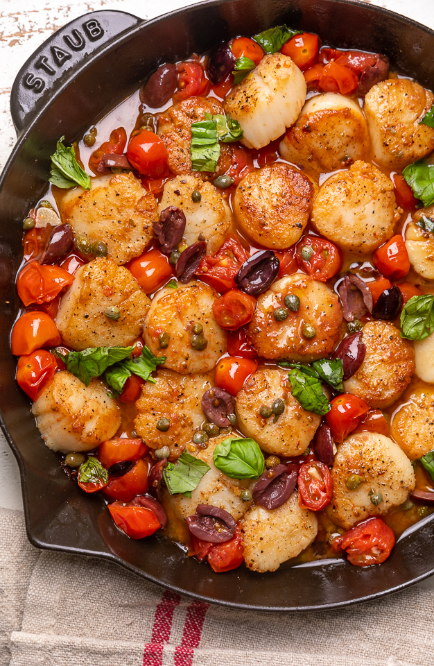Looking for an easy and flavorful seafood dish? Look no further than these Pan Seared Scallops with Tomatoes, Olives, and Capers! Delicious on their own but insanely good over pasta or a bed of asparagus!