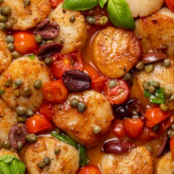 Looking for an easy and flavorful seafood dish? Look no further than these Pan Seared Scallops with Tomatoes, Olives, and Capers! Delicious on their own but insanely good over pasta or a bed of asparagus!
