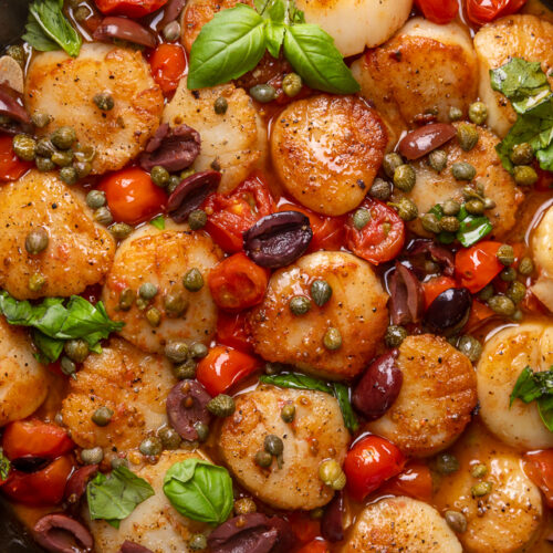 Looking for an easy and flavorful seafood dish? Look no further than these Pan Seared Scallops with Tomatoes, Olives, and Capers! Delicious on their own but insanely good over pasta or a bed of asparagus!