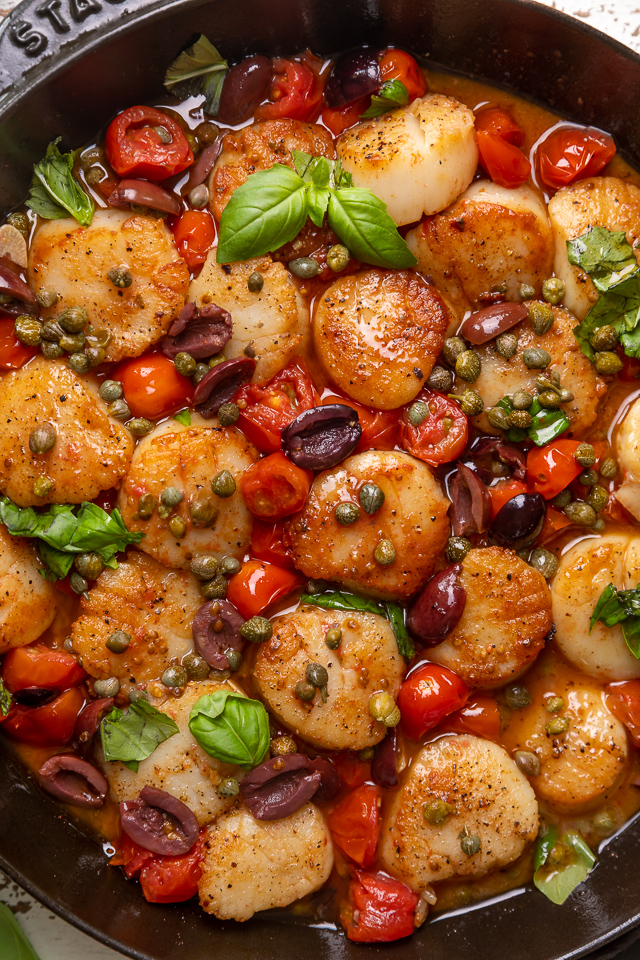 Looking for an easy and flavorful seafood dish? Look no further than these Pan Seared Scallops with Tomatoes, Olives, and Capers! Delicious on their own but insanely good over pasta or a bed of asparagus!