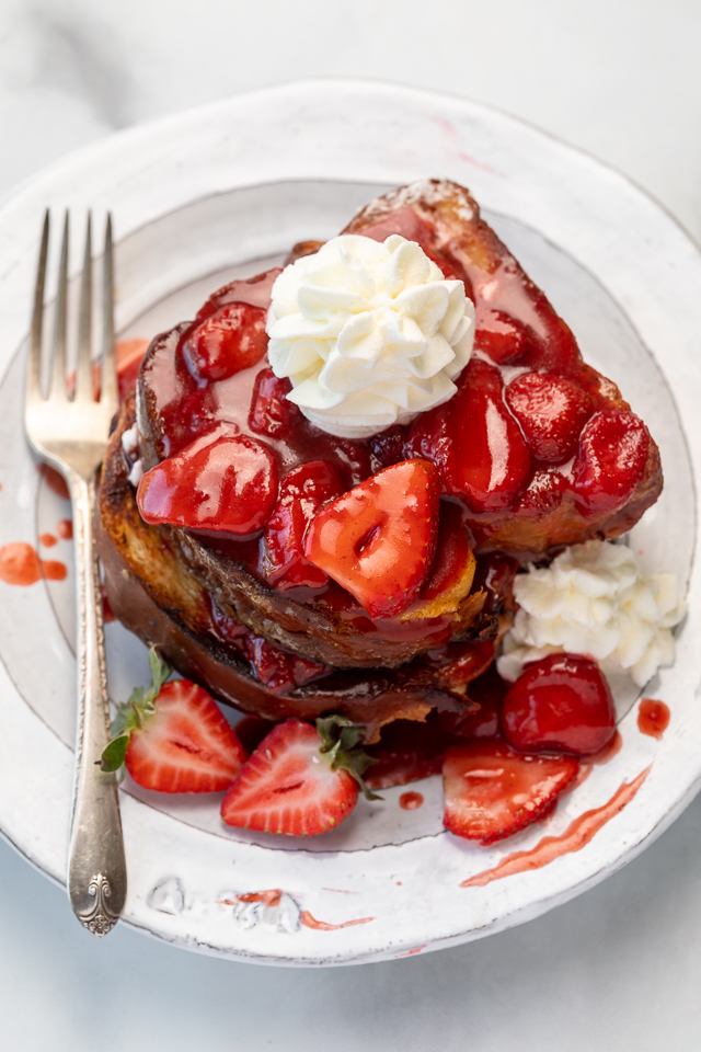 Strawberries and Cream French Toast features buttery slices of brioche bread, fresh strawberries, and whipped cream! A fancy restaurant-quality recipe that's perfect for Easter, Mother's Day, or a bridal shower brunch! This recipe can easily be doubled if you're serving a large crowd!