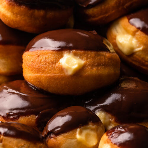 Fluffy Boston Cream Donuts are stuffed with pastry cream filling and dipped in a rich chocolate glaze! Don't let the deep frying scare you off, because this recipe is worth every step. And so much better than anything you'll get from the donut shop.