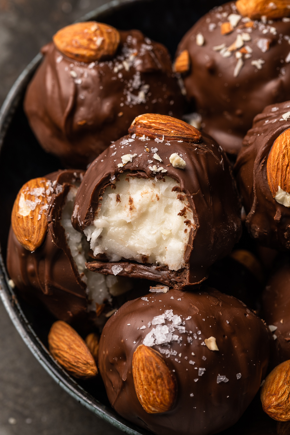 If you like almond joy candy bars, you'll love these almond joy truffles! The coconut mixture is so creamy, it almost tastes like cheesecake, and the rich robe of milk chocolate makes them so decadent! But feel free to dip in dark chocolate for a less sweet treat!