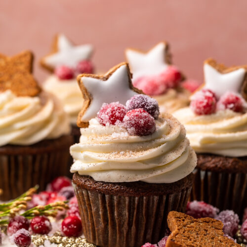 Gingerbread Cupcakes are topped with Mascarpone Frosting and Maple Candied Cranberries! Moist, fluffy, and so flavorful, these are a holiday classic! And the perfect crowd-pleasing holiday dessert recipe for your next party!