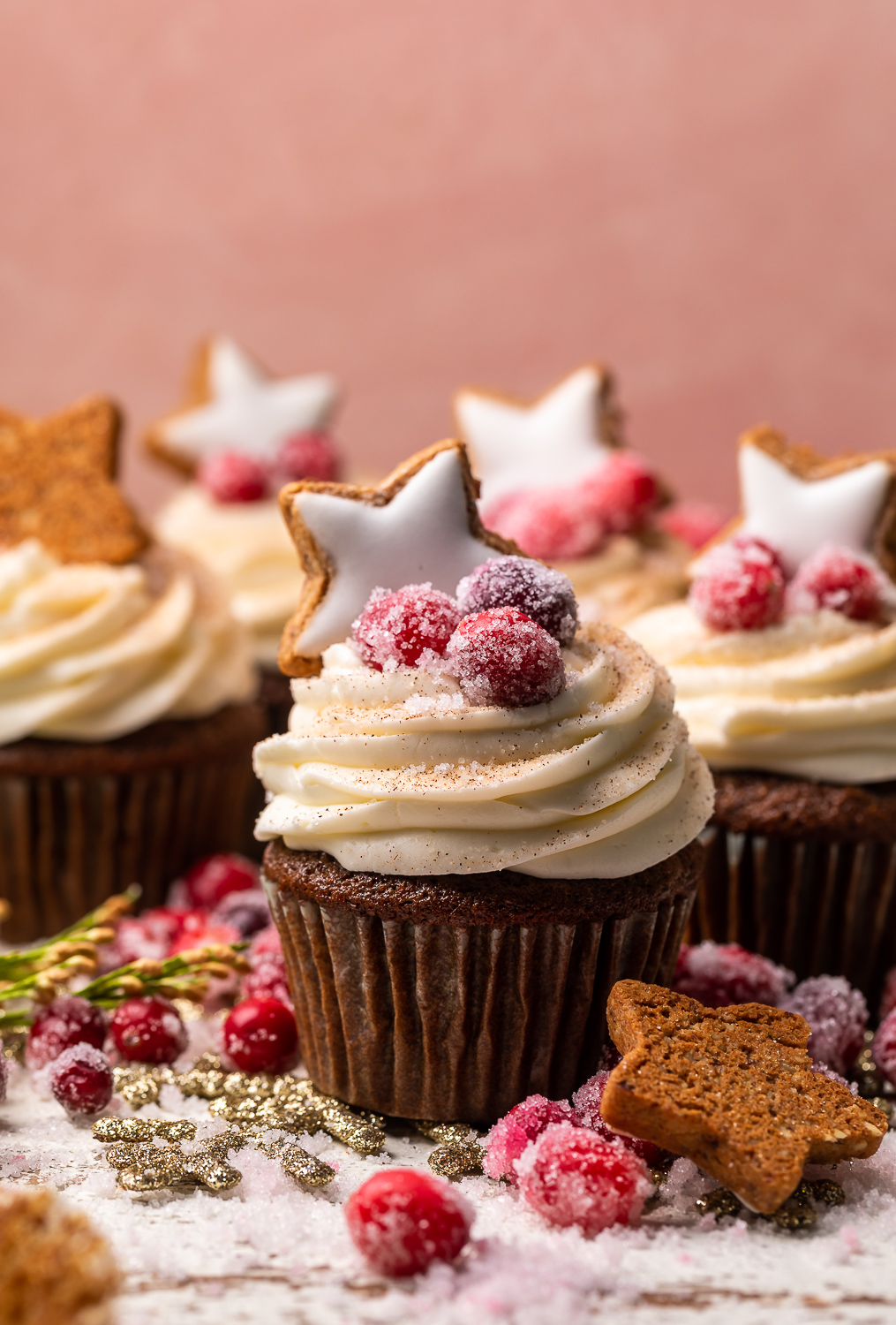 Gingerbread Cupcakes are topped with Mascarpone Frosting and Maple Candied Cranberries! Moist, fluffy, and so flavorful, these are a holiday classic! And the perfect crowd-pleasing holiday dessert recipe for your next party!