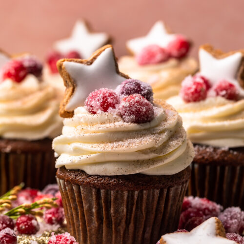 Gingerbread Cupcakes are topped with Mascarpone Frosting and Maple Candied Cranberries! Moist, fluffy, and so flavorful, these are a holiday classic! And the perfect crowd-pleasing holiday dessert recipe for your next party!