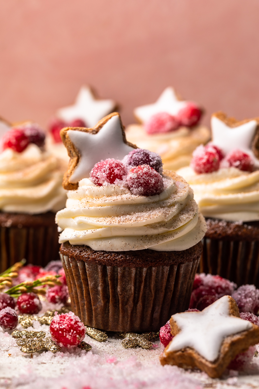 Gingerbread Cupcakes are topped with Mascarpone Frosting and Maple Candied Cranberries! Moist, fluffy, and so flavorful, these are a holiday classic! And the perfect crowd-pleasing holiday dessert recipe for your next party!