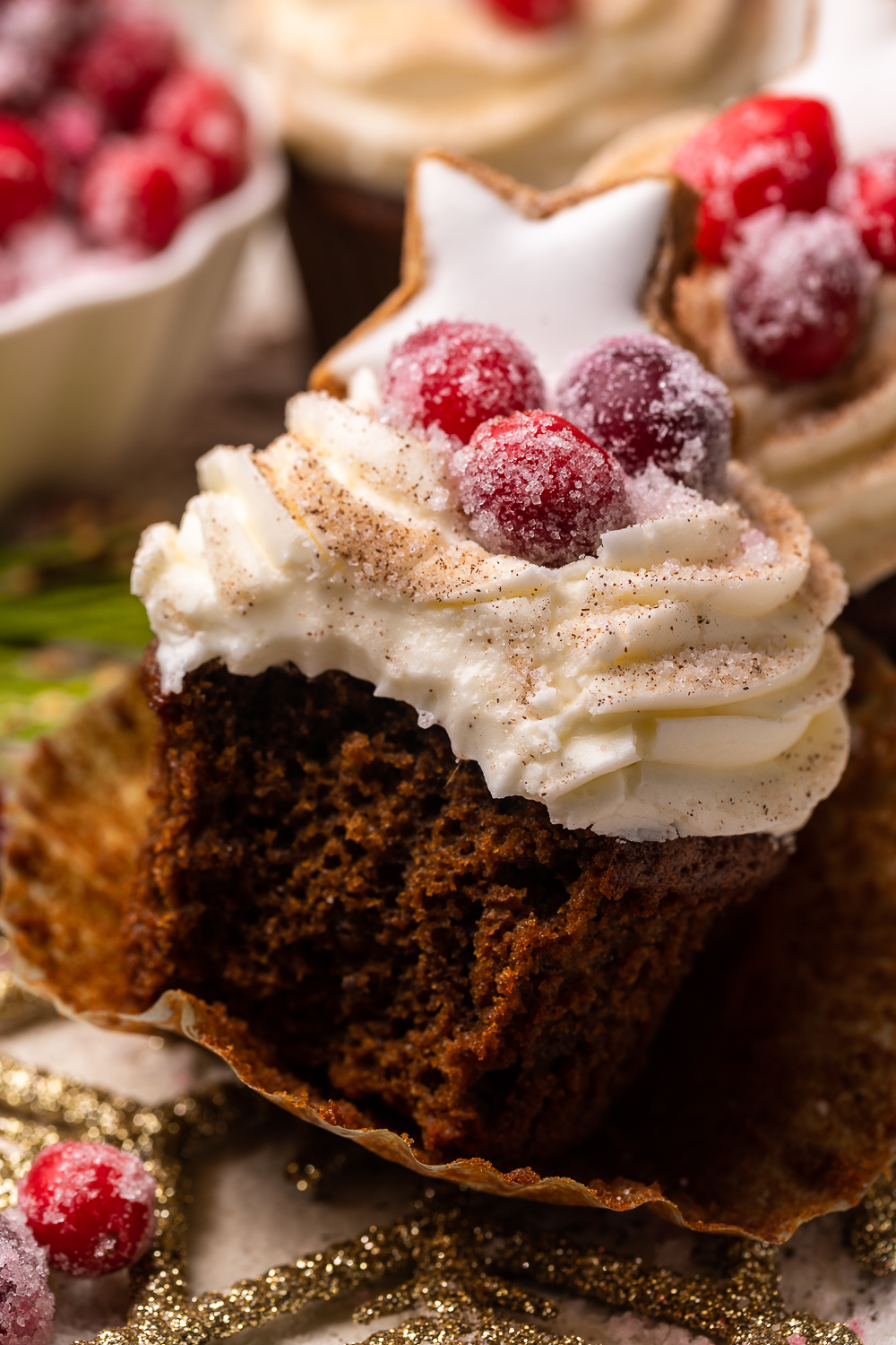 Gingerbread Cupcakes are topped with Mascarpone Frosting and Maple Candied Cranberries! Moist, fluffy, and so flavorful, these are a holiday classic! And the perfect crowd-pleasing holiday dessert recipe for your next party!