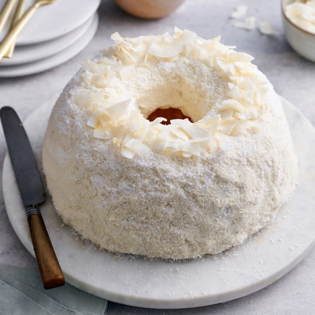 Coconut lovers go crazy over this stunning white chocolate coconut pound cake! Baked in a bundt pan, this cake is covered in sweet white chocolate frosting, shredded coconut, and flaked coconut. Dense yet light and fluffy, with plenty of coconut flavor!