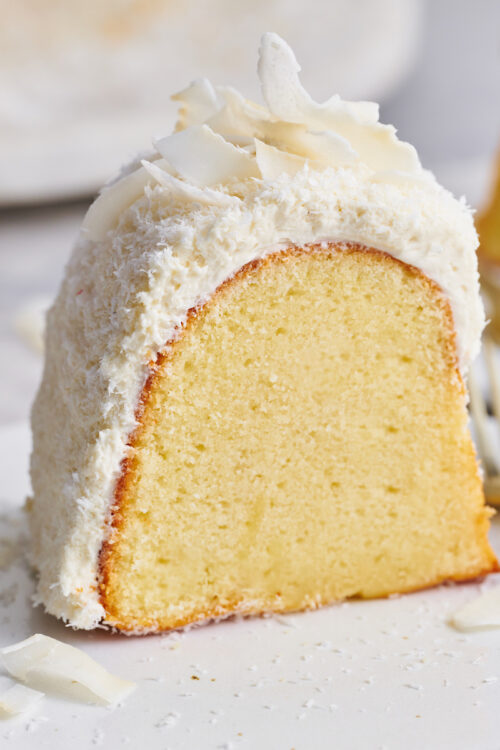 Coconut lovers go crazy over this stunning white chocolate coconut pound cake! Baked in a bundt pan, this cake is covered in sweet white chocolate frosting, shredded coconut, and flaked coconut. Dense yet light and fluffy, with plenty of coconut flavor!