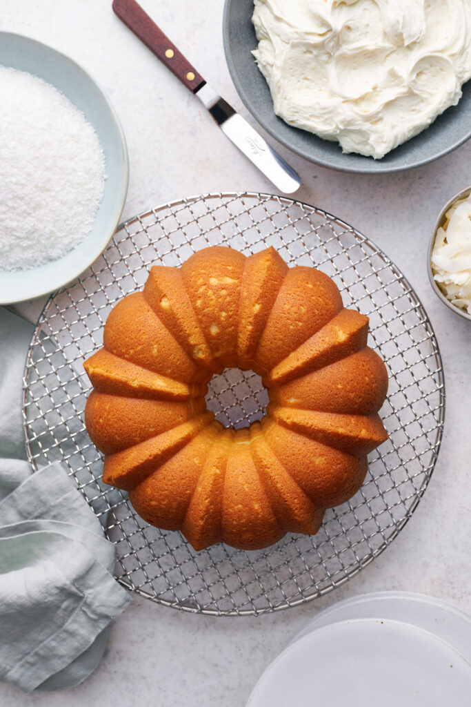 Coconut lovers go crazy over this stunning white chocolate coconut pound cake! Baked in a bundt pan, this cake is covered in sweet white chocolate frosting, shredded coconut, and flaked coconut. Dense yet light and fluffy, with plenty of coconut flavor!