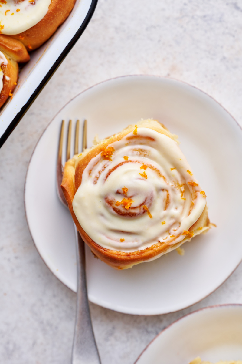 Soft and fluffy orange rolls are loaded with fresh orange flavor and slathered in cream cheese frosting! This special breakfast treat is a Christmas morning tradition in our house... but they're so good we've started making them for Easter, Mother's Day and sometimes, just because! Serve warm, straight from the baking dish!