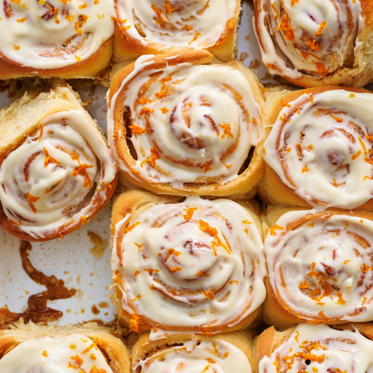 Soft and fluffy orange rolls are loaded with fresh orange flavor and slathered in cream cheese frosting! This special breakfast treat is a Christmas morning tradition in our house... but they're so good we've started making them for Easter, Mother's Day and sometimes, just because! Serve warm, straight from the baking dish!