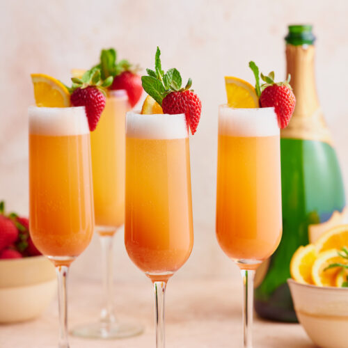 Everyone knows how to make a classic mimosa, so today I'm teaching you how to make my special sunrise strawberry mimosa recipe! Made with strawberry puree, champagne, and fresh squeezed orange juice, these are perfect for brunch! Garnish with mint sprigs, strawberries, and orange slices for an extra pretty presentation!