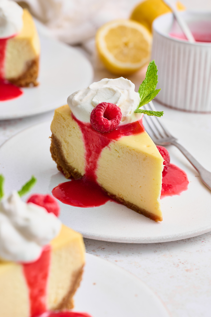 This stunning lemon ginger cheesecake is rich, cream, and silky smooth! Made with fresh ginger, lemon juice, and lemon zest, it's bursting with fresh flavor. The hot pink raspberry sauce makes it a total showstopper!