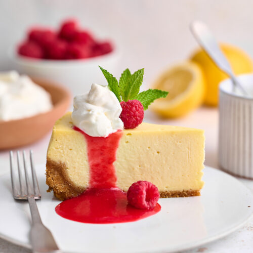 This stunning lemon ginger cheesecake is rich, cream, and silky smooth! Made with fresh ginger, lemon juice, and lemon zest, it's bursting with fresh flavor. The hot pink raspberry sauce makes it a total showstopper!