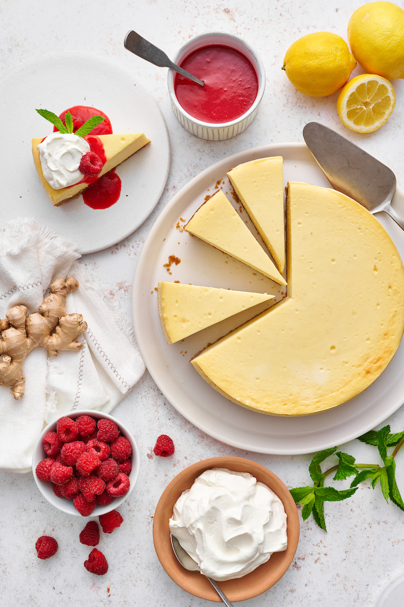 This stunning lemon ginger cheesecake is rich, cream, and silky smooth! Made with fresh ginger, lemon juice, and lemon zest, it's bursting with fresh flavor. The hot pink raspberry sauce makes it a total showstopper!
