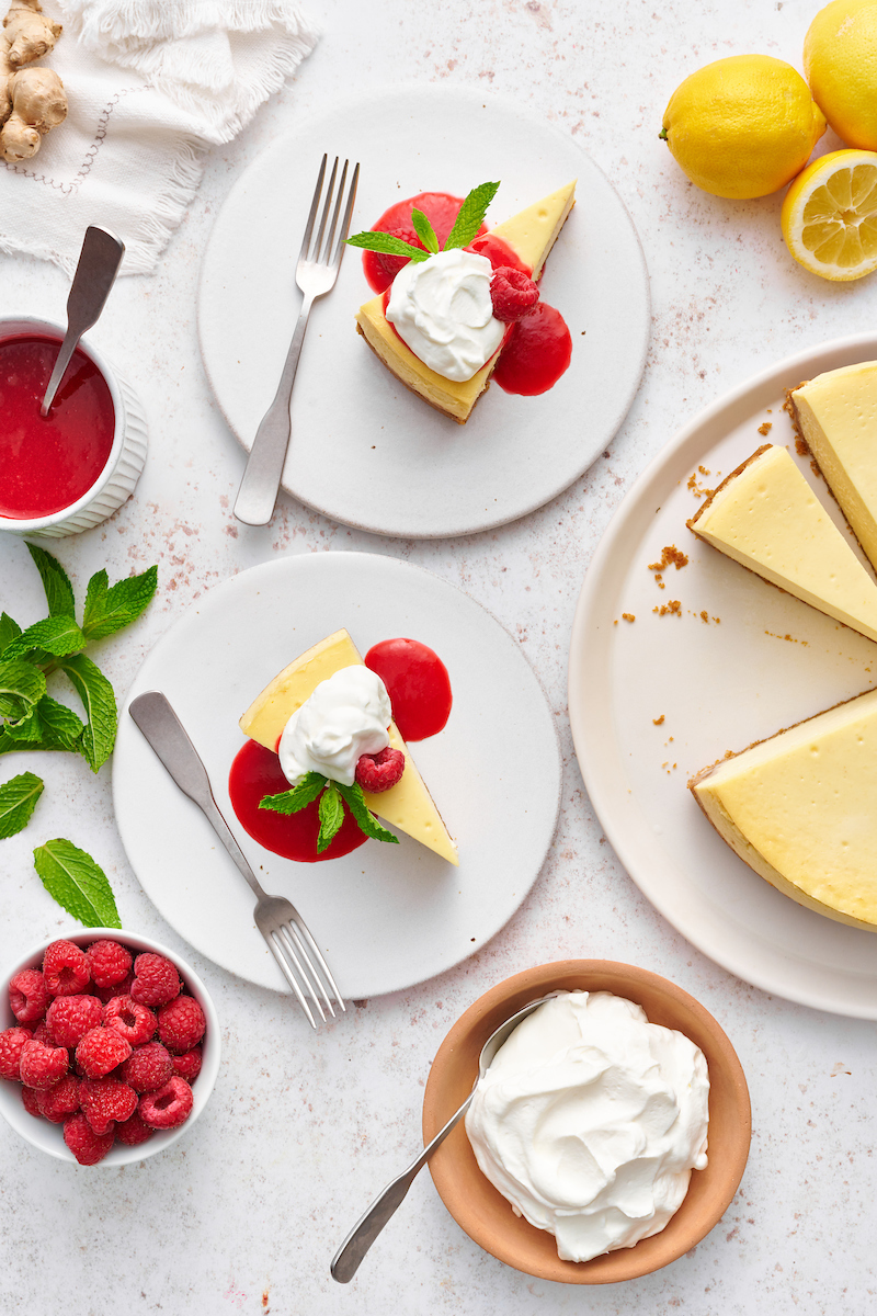 This stunning lemon ginger cheesecake is rich, cream, and silky smooth! Made with fresh ginger, lemon juice, and lemon zest, it's bursting with fresh flavor. The hot pink raspberry sauce makes it a total showstopper!