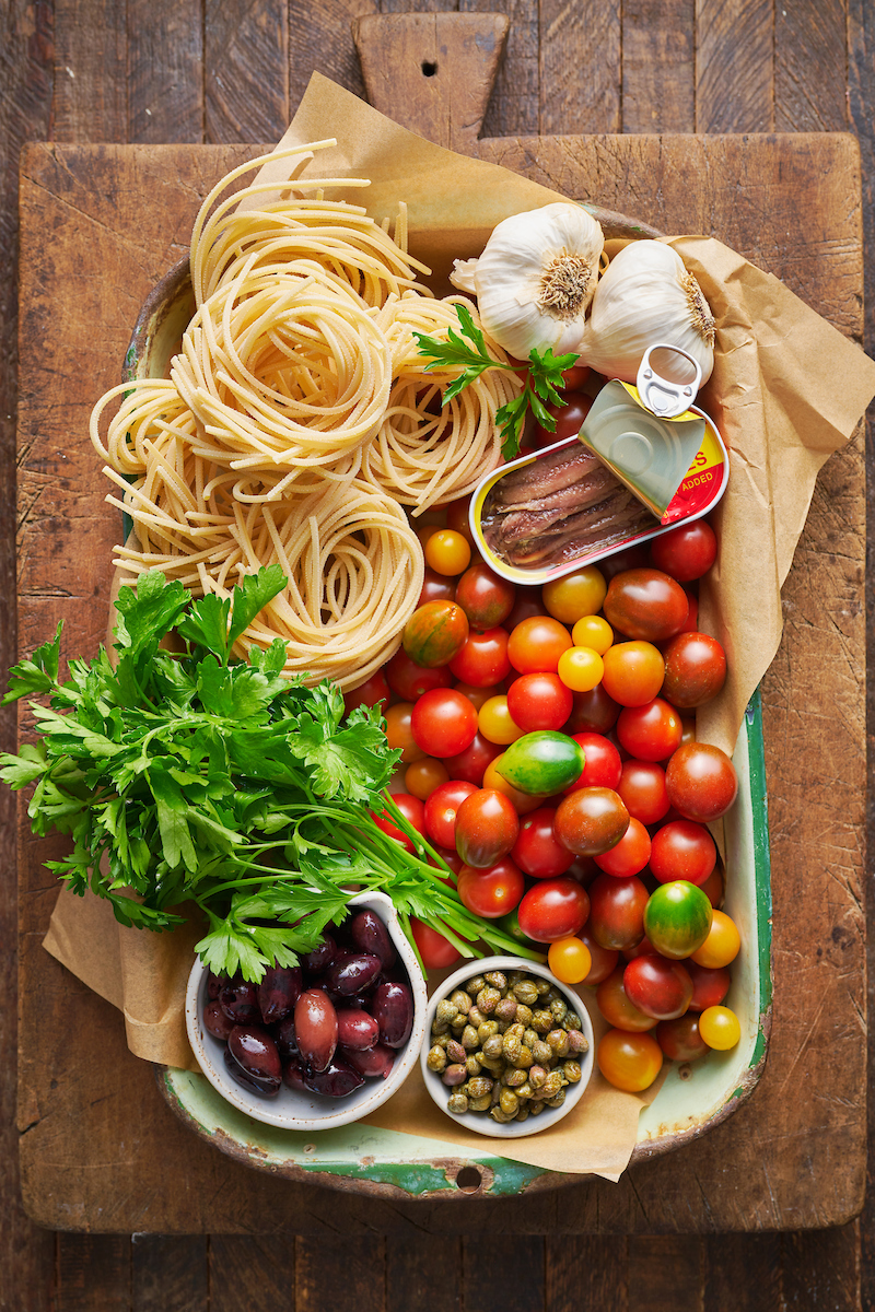 If you're looking for some dinner inspiration, allow me to tempt you with this fresh tomato pasta puttanesca. The tomato based puttanesca sauce is made from pantry staples like anchovy fillets, capers, and black olives. And it gets tossed with al dente pasta (any variety will work) for a classic Italian pasta dish the whole family will enjoy!